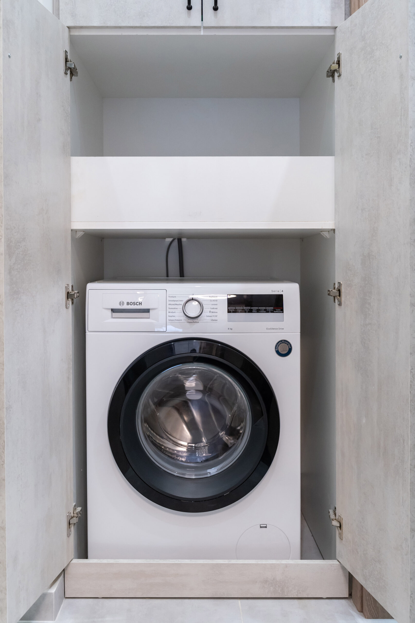 Integrated washing machine Washing machine integrated into apartment cabinetry